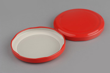 Screw caps for glass jars. For canning, canned food. Red caps on gray background