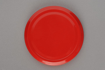 Screw cap for glass jars. For canning, canned food. Red cap on gray background