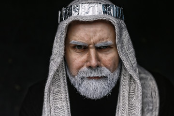make-up man with a beard / concept oriental portrait in traditional dress, gray-haired white beard...