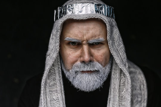 make-up man with a beard / concept oriental portrait in traditional dress, gray-haired white beard in an Arab man