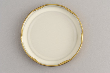 Screw cap for glass jars. For canning, canned food. Golden cap on gray background flip cover