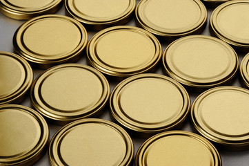 Screw caps for glass jars. For canning, canned food. Golden caps on gray background