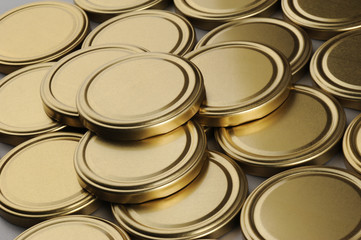 Screw caps for glass jars. For canning, canned food. Golden caps on gray background