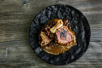 top view grilled meat steak with blood decorated with sauce