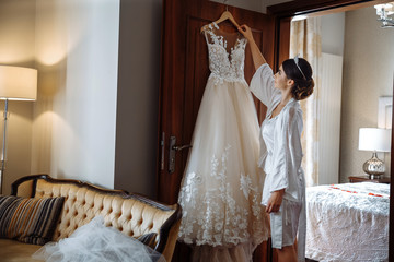 beautiful bride takes a wedding dress