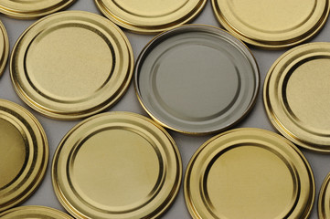 Screw caps for glass jars. For canning, canned food. Golden caps on gray background