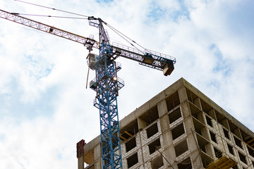Fototapeta na wymiar Construction. Construction of residential buildings in Moscow. A crane with buildings and sky in the background.