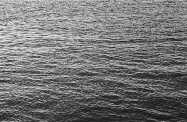 Water surface black and white abstract background. Calm water monochrome view