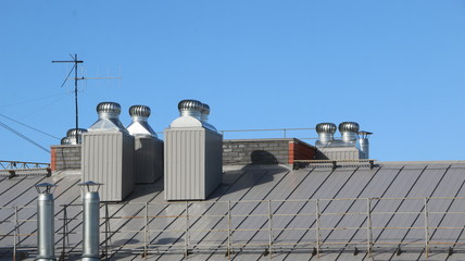 shiny metal air ventilation on roof rotates to clean  air in  building and regulate  temperature.