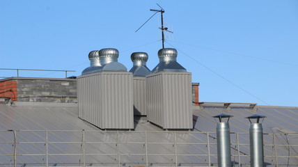 shiny metal air ventilation on roof rotates to clean  air in  building and regulate  temperature.