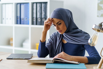 Female Muslim student concentrated