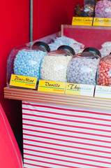 Nuremberg, Germany 04 20 2013: Glasses filled with sugar bonbons and hard candy in different fruit flavors and shapes at vendor booth at traditional, historic Easter Market at Hauptmarkt square