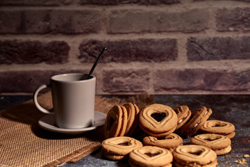 delicious bunch of sweet cookies next to a rich cup of hot milk