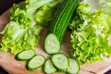 cucumber and lettuce on chopping board