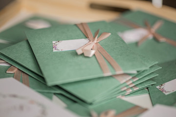 Delicate green envelopes with soft pink bows. Wedding invitation cards. Autumn Wedding Invitation. 