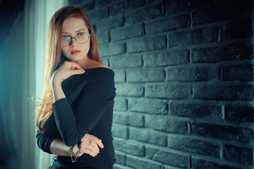 Fototapeta na wymiar serious young woman with glasses / businesswoman serious look in glasses. concept vision business, youth