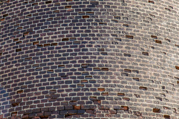 Fragment of the wall of an old brick water tower