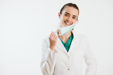 Young nurse in a scrub uniform wearing a face mask.
