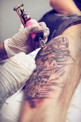 Session of tattooing in studio during making picture on calf