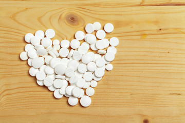 Assorted pharmaceutical medicine pills, tablets  on wooden background