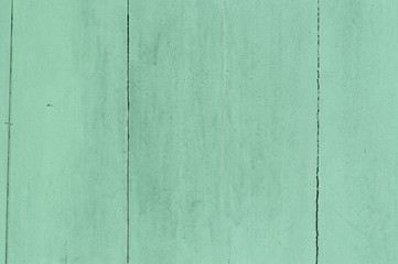 Obraz premium Faded green or blue wooden background with some cracked spots and vertical pattern on it