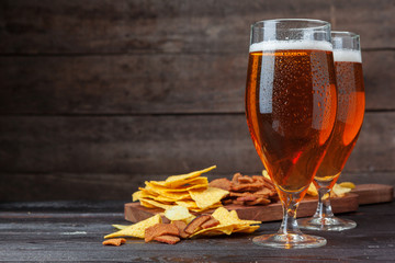 A selection of beer and snacks on wooden background