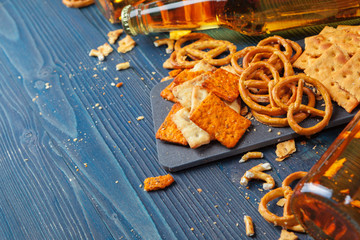 A selection of beer and snacks on wooden background