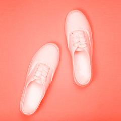 White sneakers on a coral background