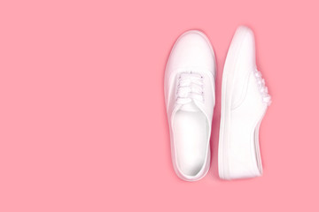 White sneakers on pink background, flat lay,copy space..Fashion trend shoe