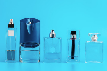 Man perfume bottle on blue background close up