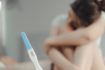 Naklejka premium Young asian woman looking at pregnance test.
