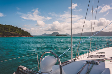 Sailboat sailing on a warm beautiful day in the Whitsunday Islands on the Great Barrier Reef in Australia.