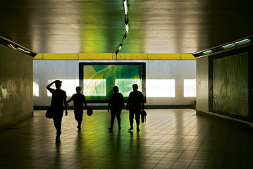 Four pedestrians passing an underground tunnel in Manila