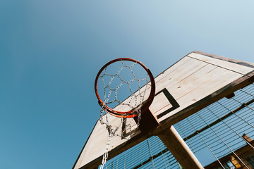 old basketball hoop against blue sky