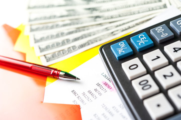 Business and financial background with dollars, data, pen and calculator. Bookkeeping background.