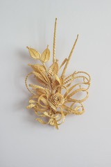 Decoration of straw on a white background. Branch with flowers. Decor. The products are made of straw 