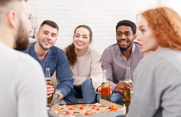 Friends meet together. Students eating pizza and talking