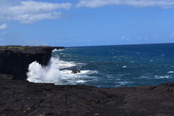 Sea Cliff at Volcano National Park HI waves crashing against volcanic rock creating foam and surf