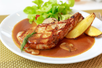 grilled pork chop with vegetable on disk