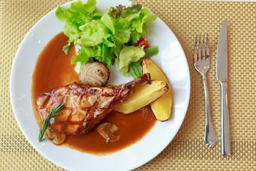 grilled pork chop with vegetable on disk