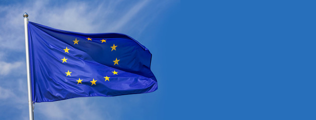 Flag of the European Union waving in the wind on flagpole against the sky with clouds on sunny day, banner, close-up - obrazy, fototapety, plakaty