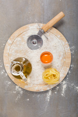 Italian raw homemade pasta tagliatelle at concrete table