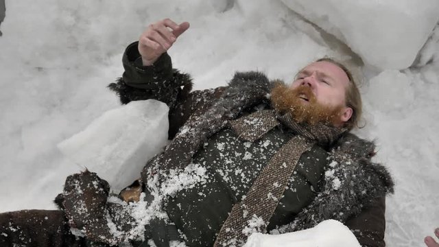 Medieval man lying under block of ice