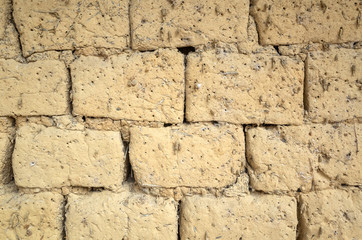 old yellow mud brick wall background