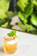 Cocktail with orange bitter and orange peel and mint leave