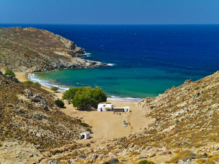 Fototapeta na wymiar Beautiful greek summer sunny beach bay. View to aegean blue sea with awesome turquoise water. Island paradise. Psili Ammos Beach, Patmos Island, Dodecanese, Greece