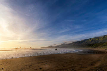 Fototapeta na wymiar Sandy Beach at Sunset and Blue Sky