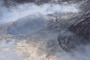 Arial View of Mauna Loa Volcano Crater Hawaii smoke rising from the crater as it is errupting
