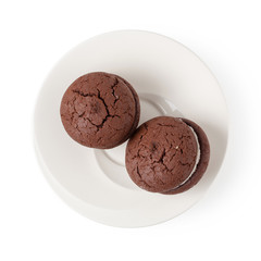 Sandwich chocolate cookies and cream on a white plate isolated over white background