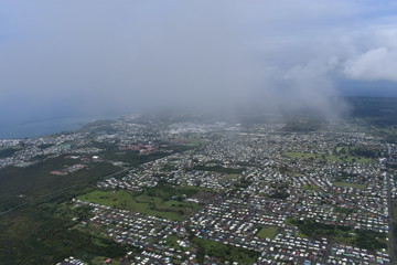 Arial view of Hilo Hawaii from above the clouds. Tourism showing the city from a helicopter